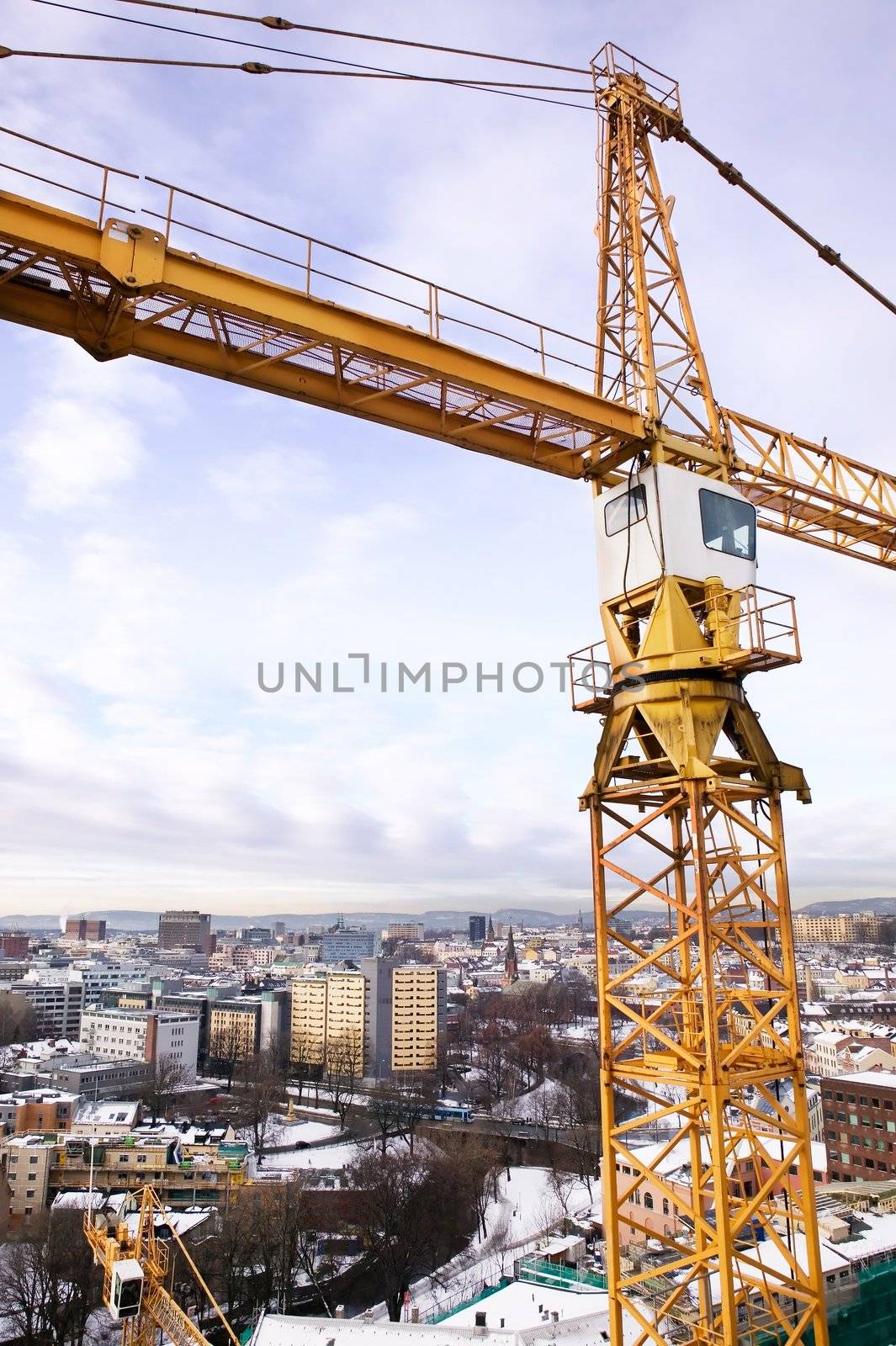 A detail of a crane overlooking the Oslo fjord and city of Oslo.