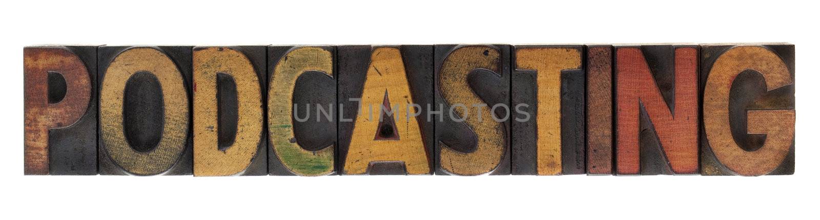 word of podcasting in vintage wood block letterpress type, stained by ink, isolated on white