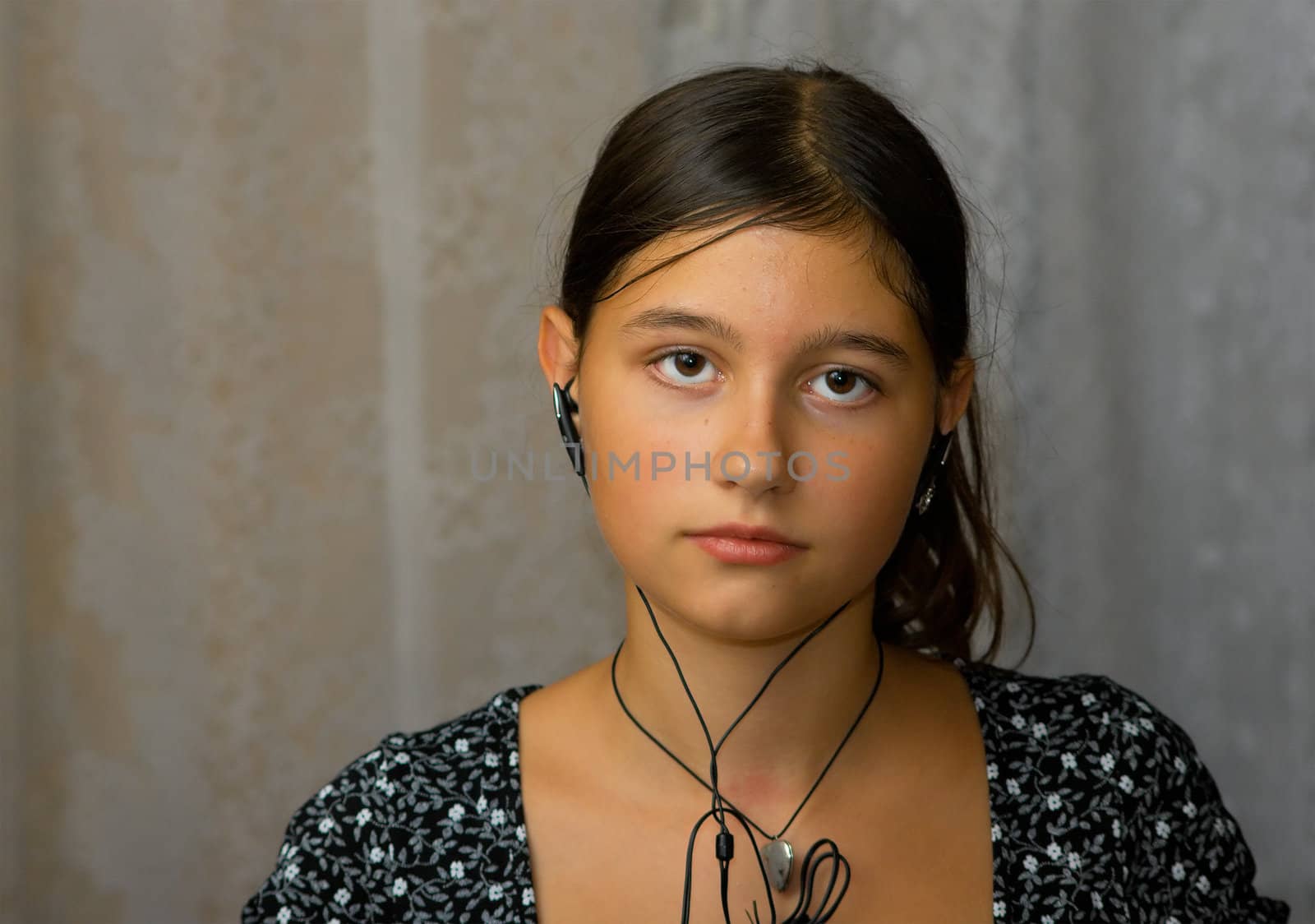 The girl in ear-phones from a mp3-player listens to music