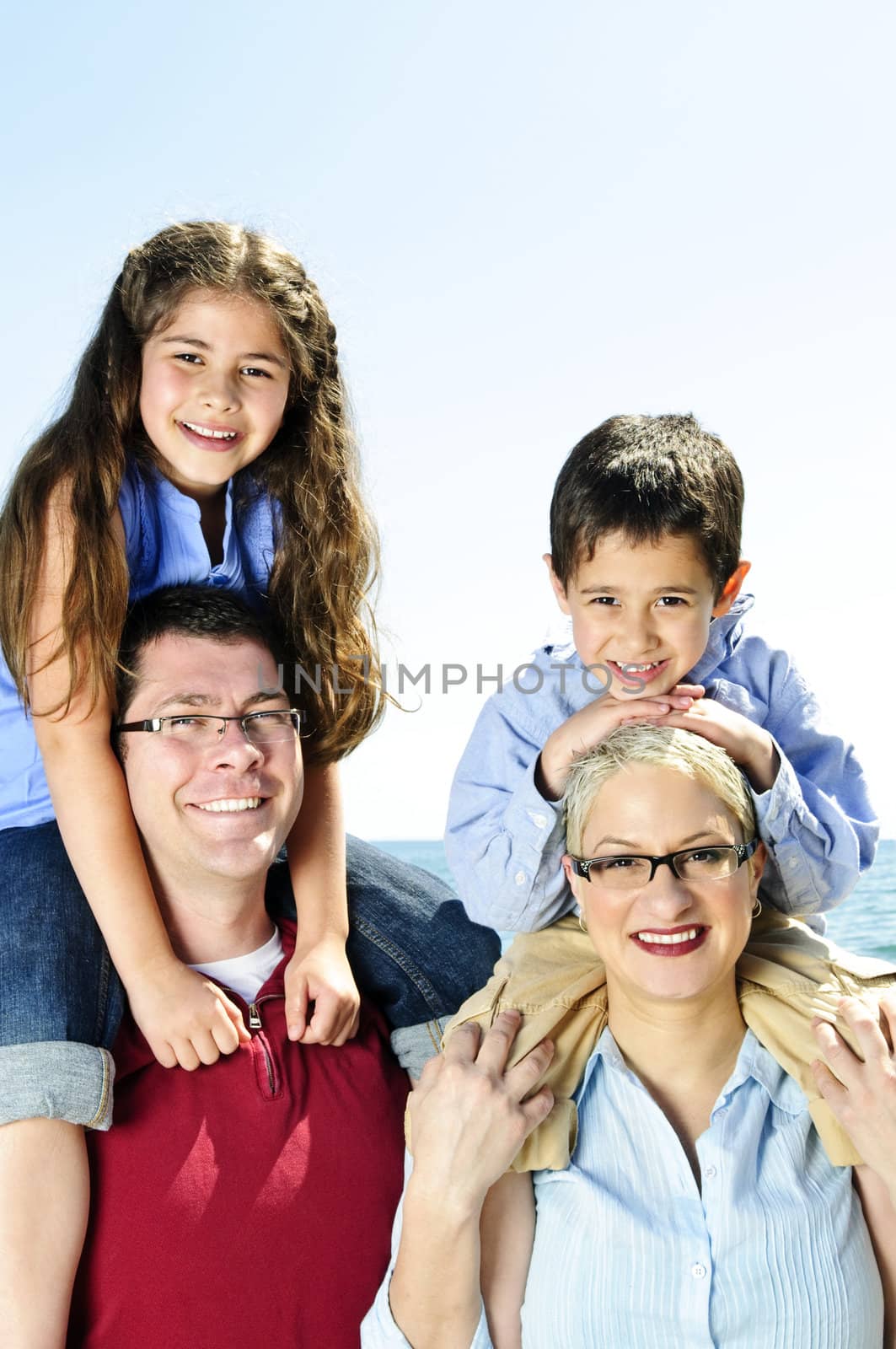 Happy family having fun giving shoulder rides