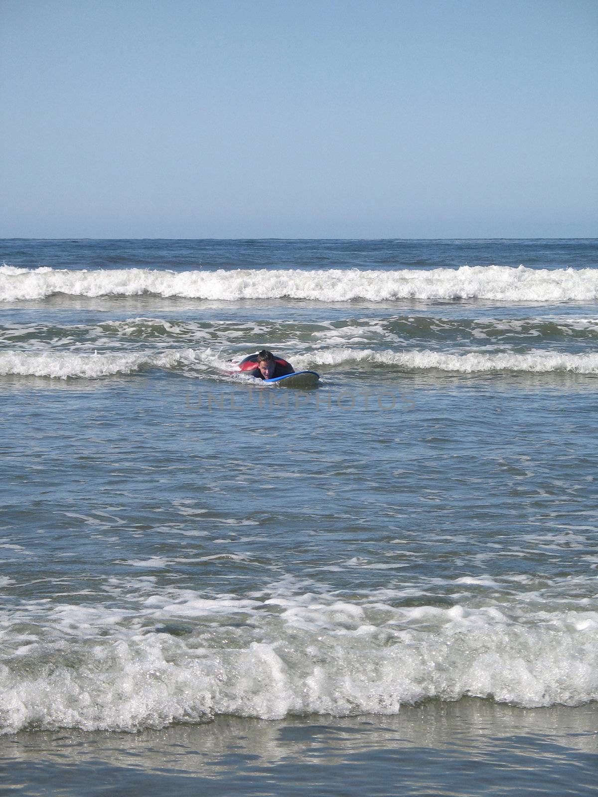 surfer on it's board in the ocean by mmm