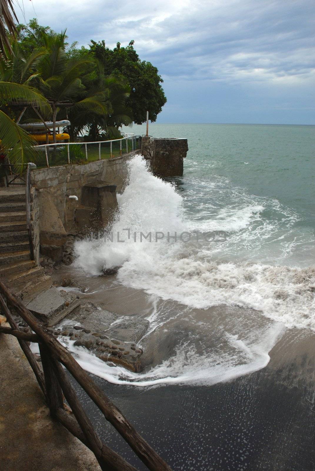 Wave breaking on the walkway of the cliff  by cienpies