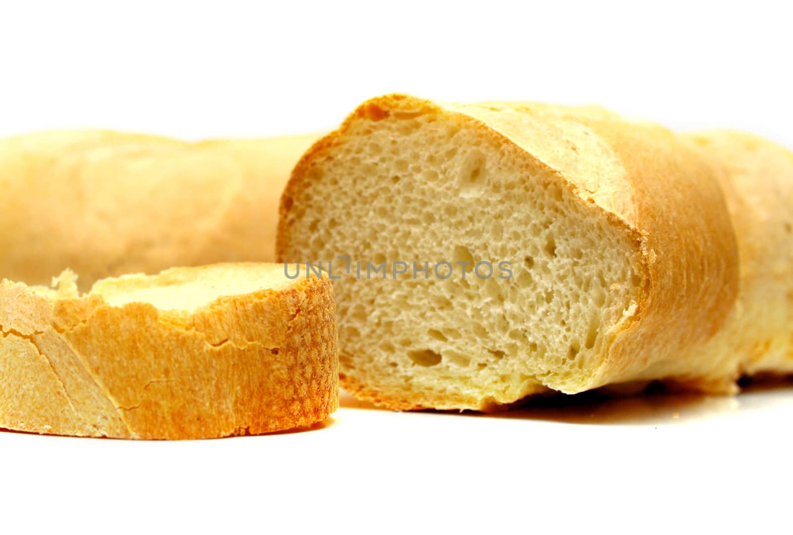 Fresh tasty bread which is cut on a part. Isolation on white. Shallow DOF.