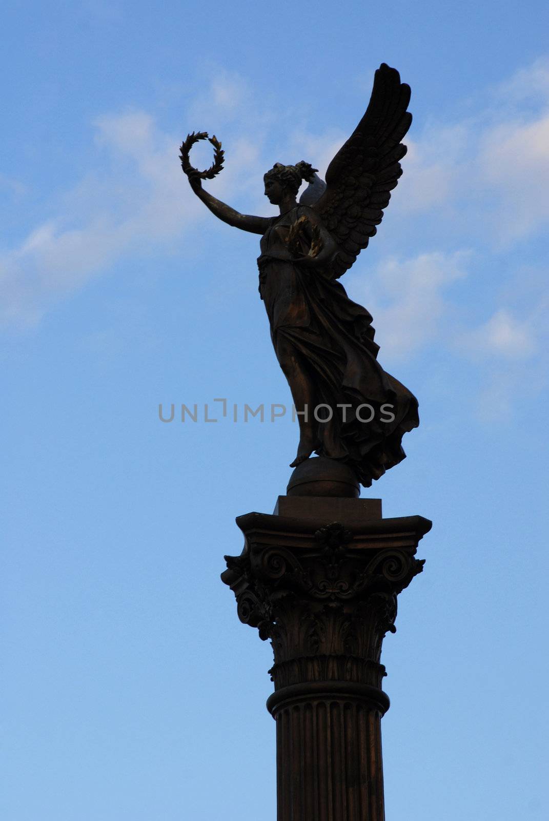 Silhouette of the Golden muse statue, the head of the candelabrum. Prague