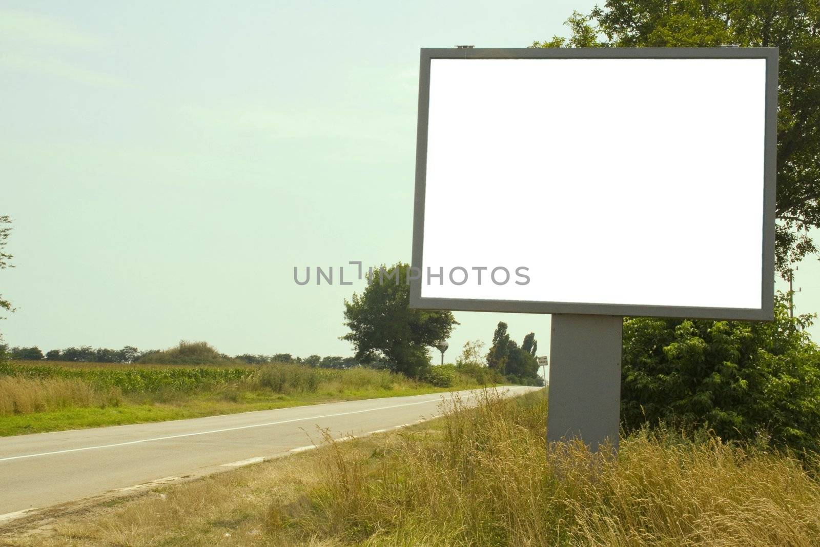 Deserted road with white billboard
