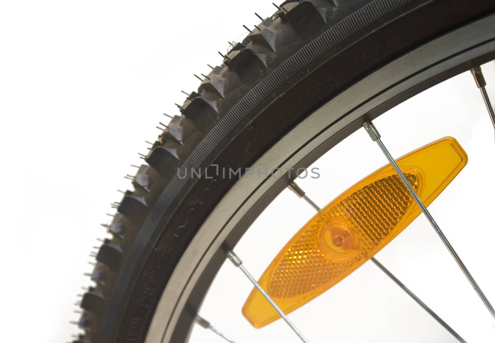 Close-up of a mountain bike tyre with reflector