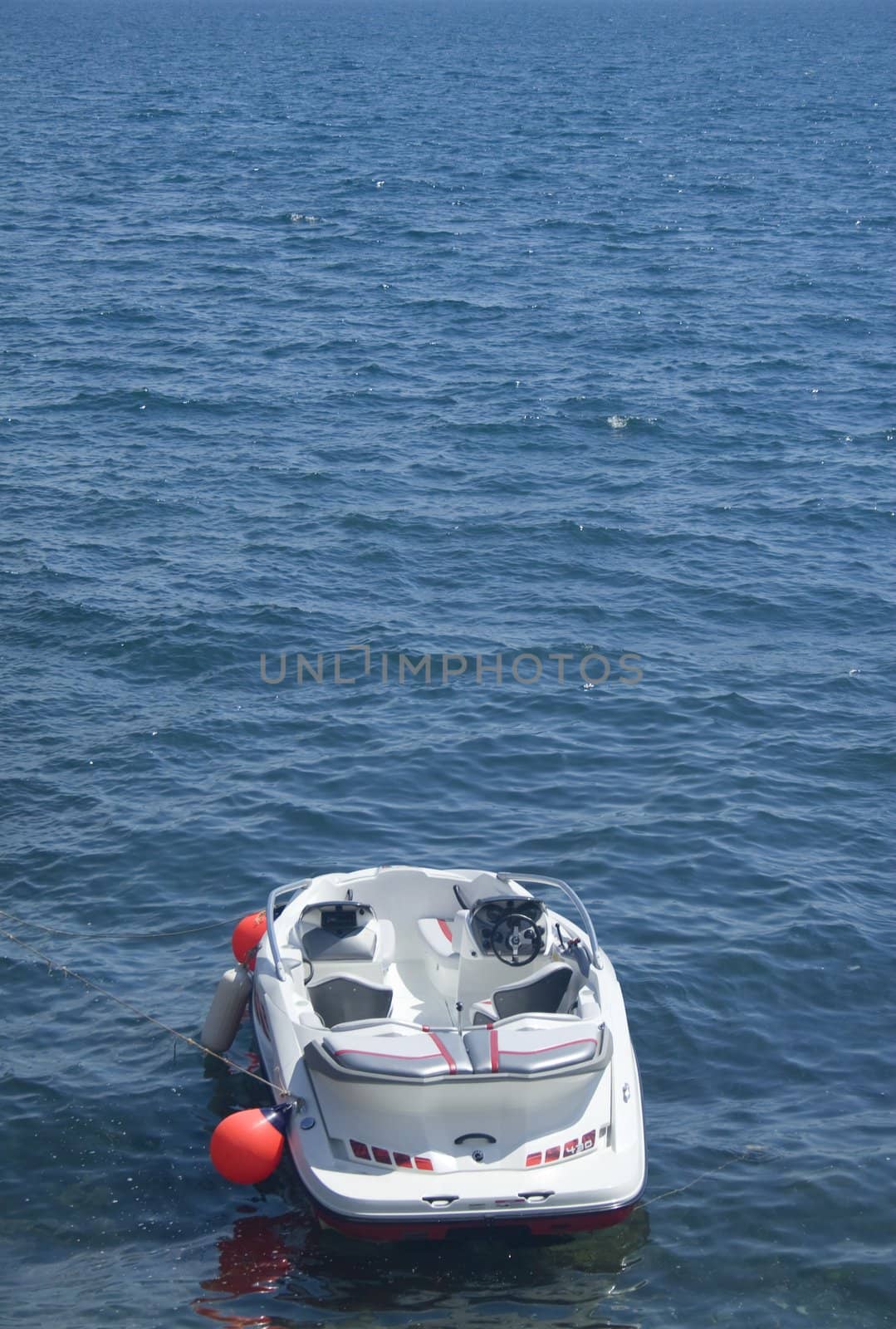 Small motorboat floating alone near buoy