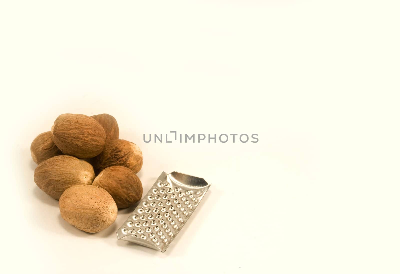Nutmeg and grater isolated on white