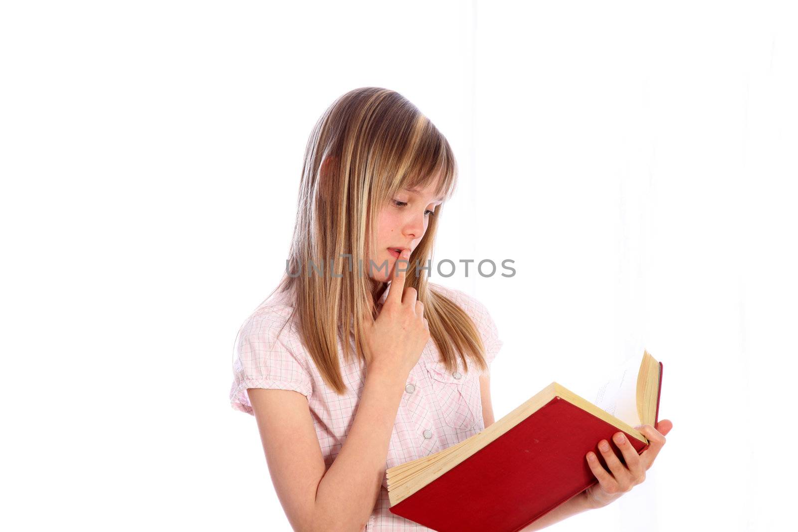 A pensive blond girl with a red book in his hand against a white background