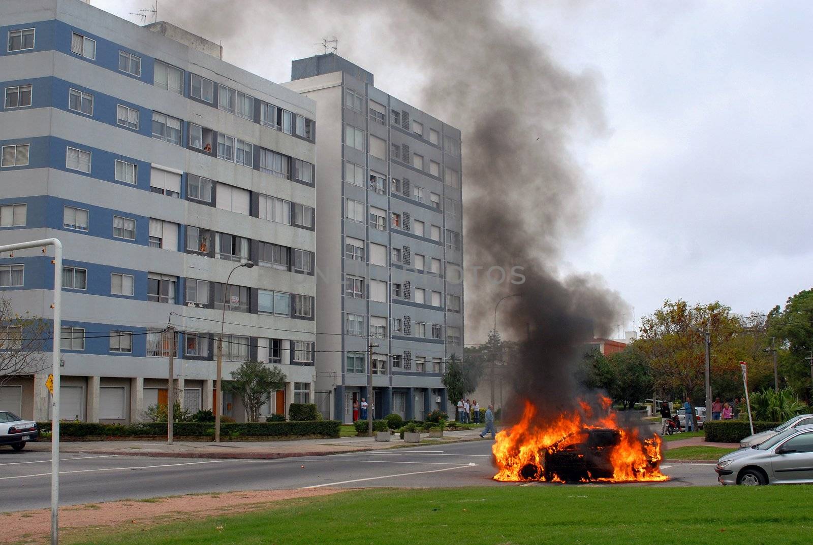 Car fire on the street and smoke rising up. Advanced stage of a  by cienpies