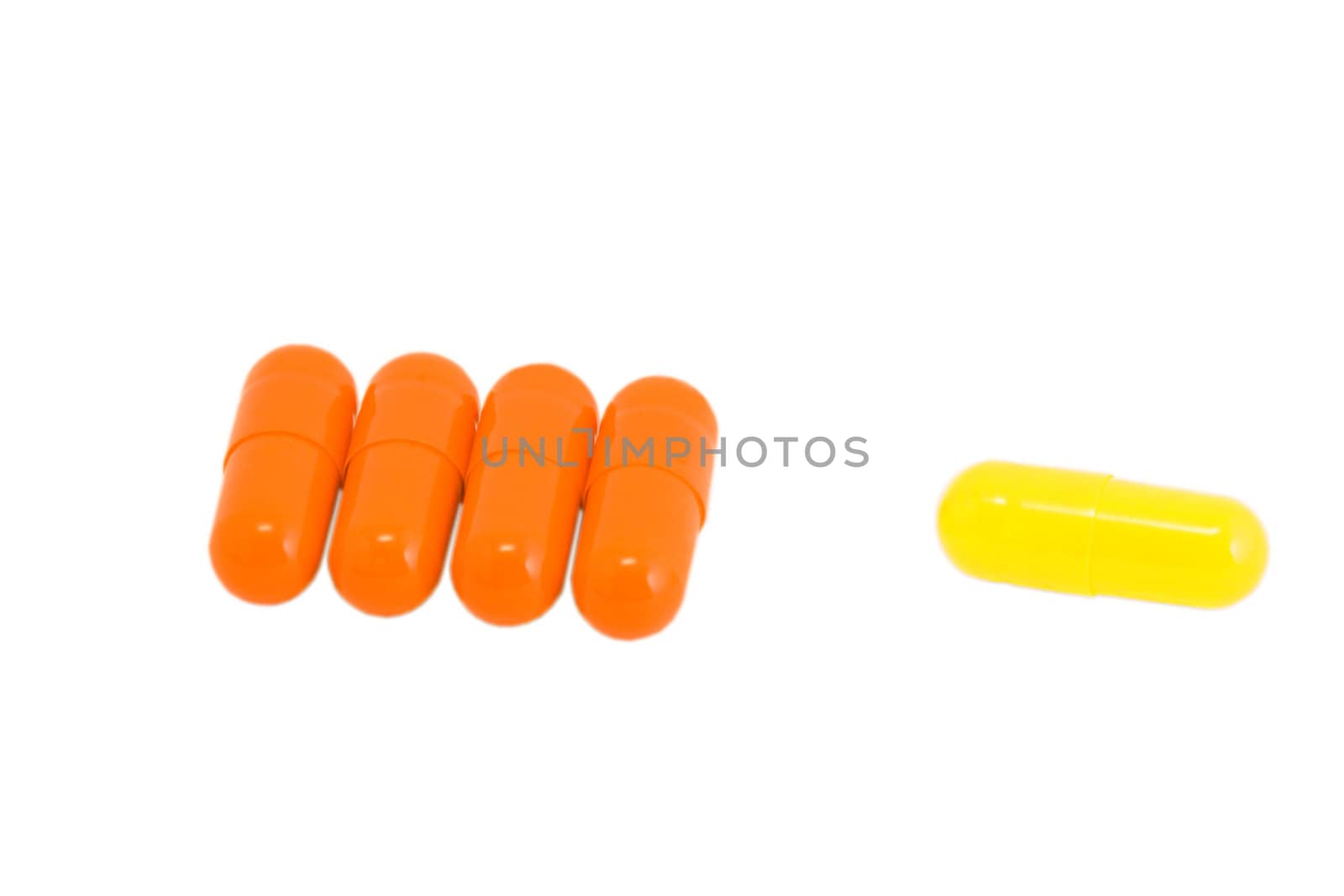 Few vitamin pills on isolated white. Make your choice