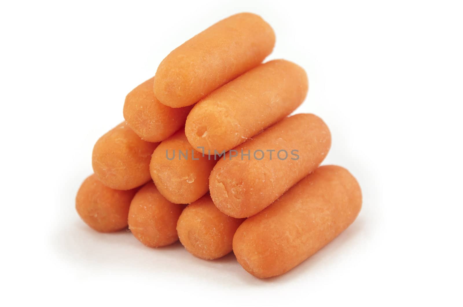 A heap of clean and peeled carrots isolated on white