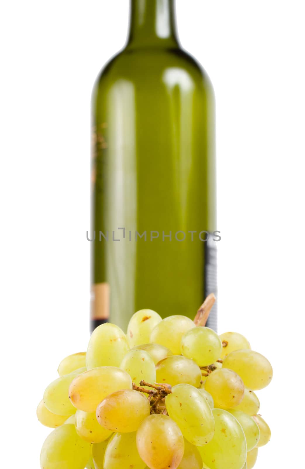 close-up bottle and green grapes, isolated on white