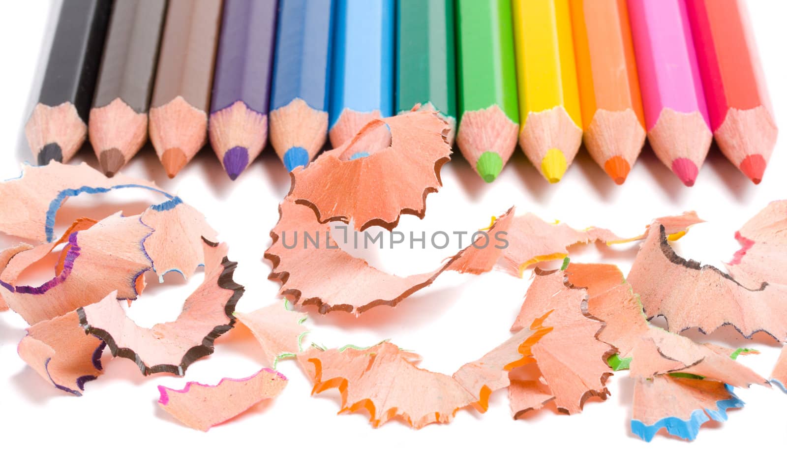 close-up sharpening a color pencils, isolated on white