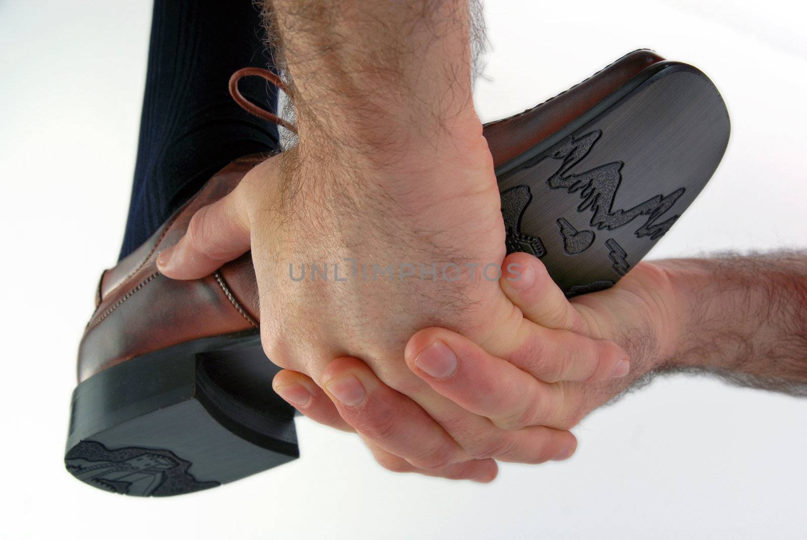 Hands boosting a male shoe on white background