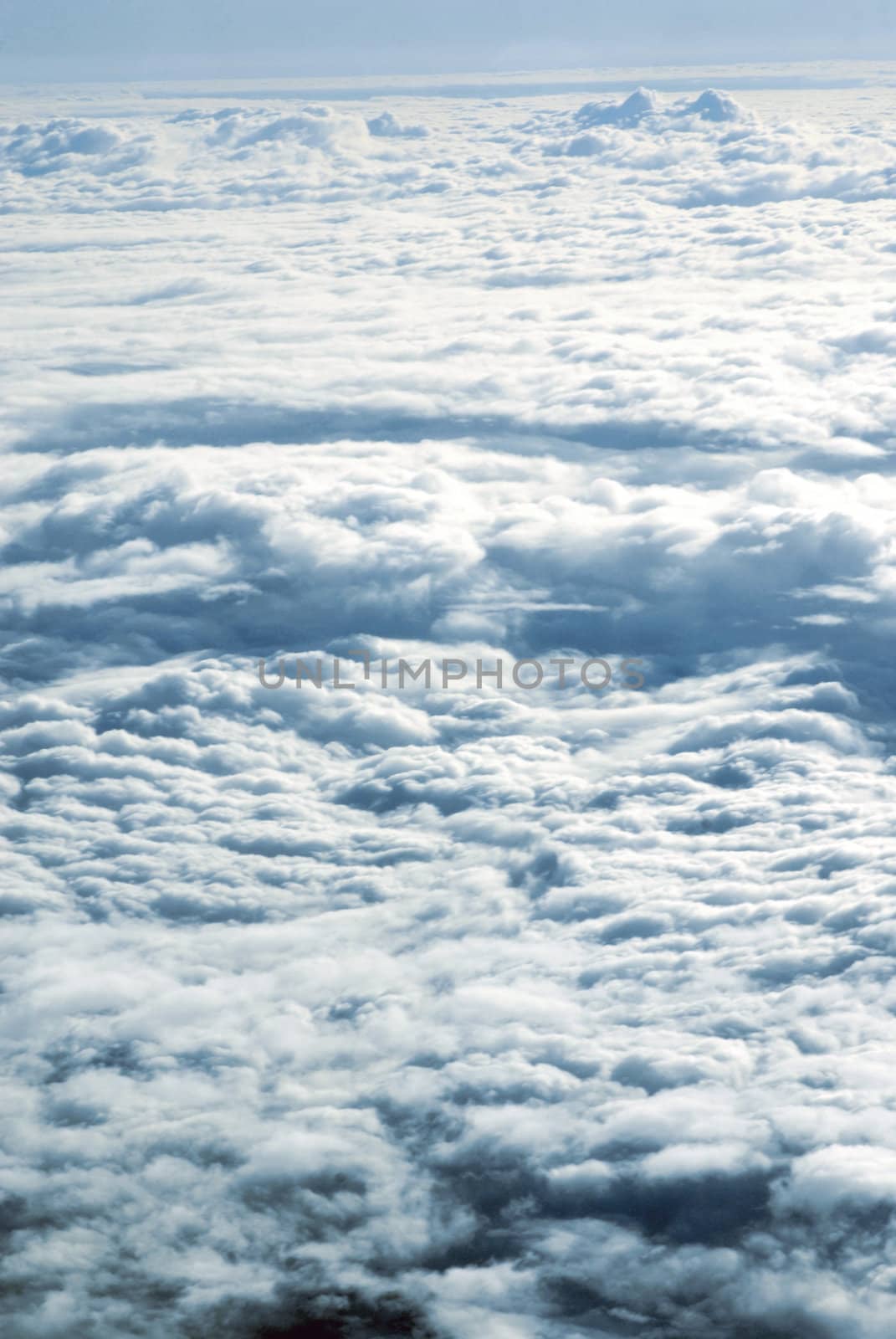 View from a plane above clouds by cienpies