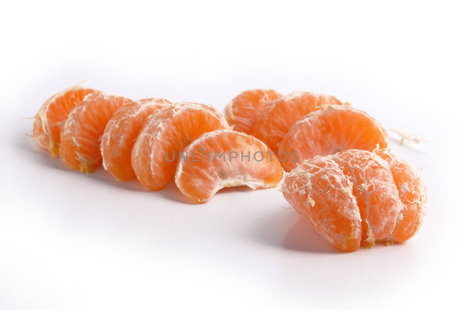 Juicy tangerine slices. Fresh fruit isolated on white background