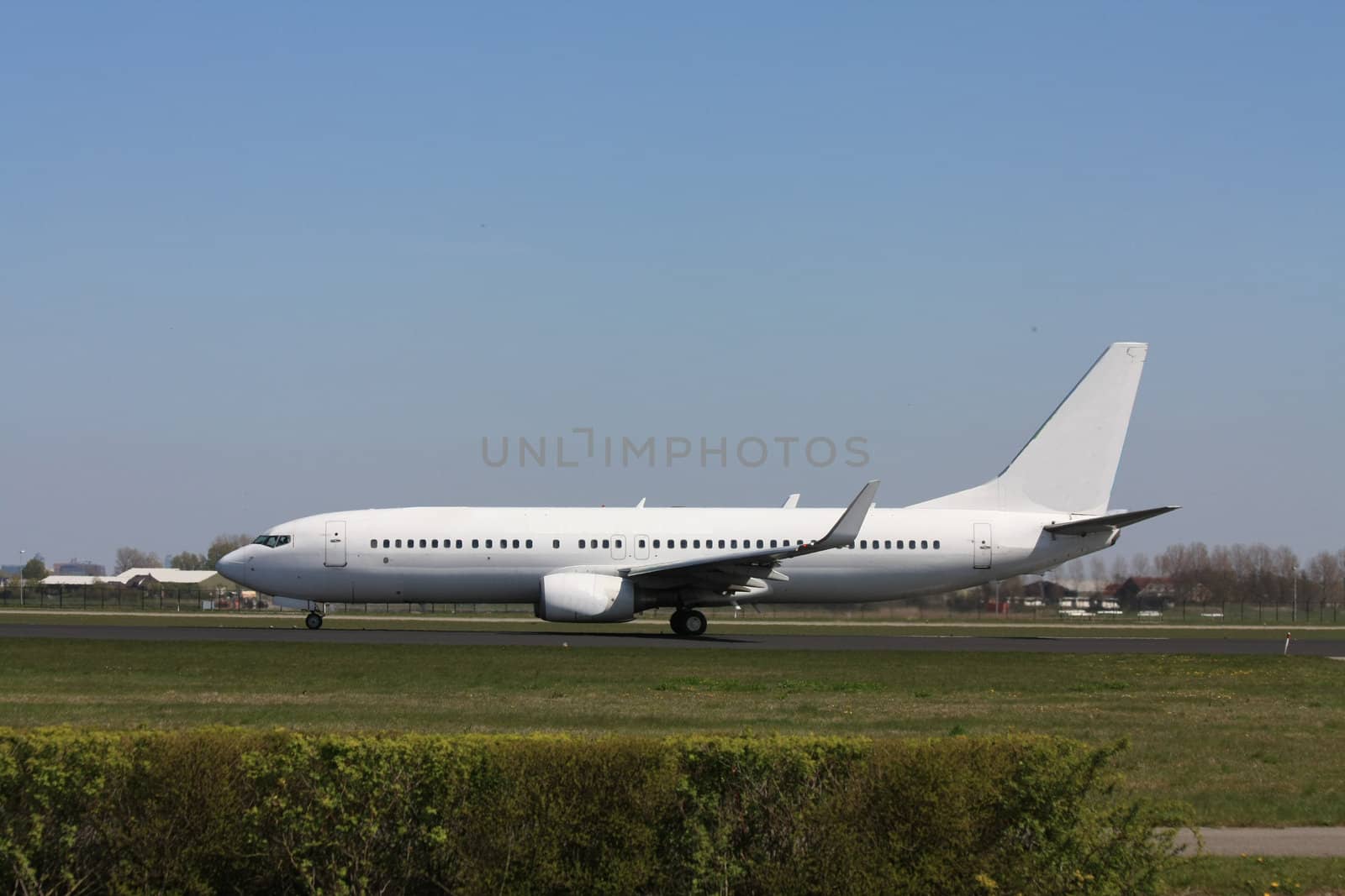 A white airplane on the runway, seconds before take off