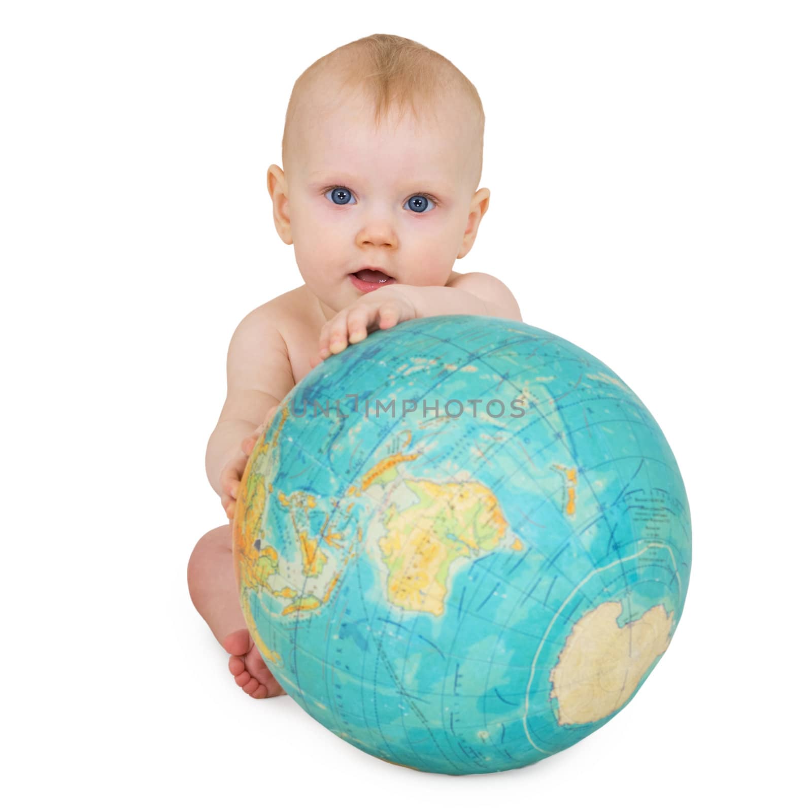 A baby sitting on a white background with a globe