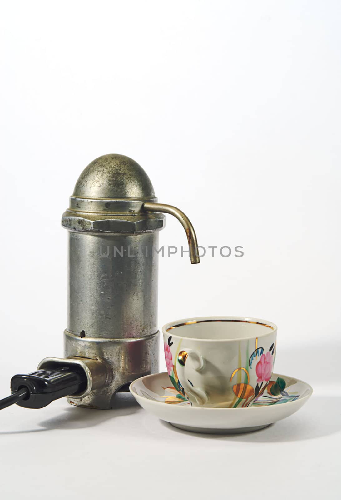 old aluminium electrical  coffee machine  and cup