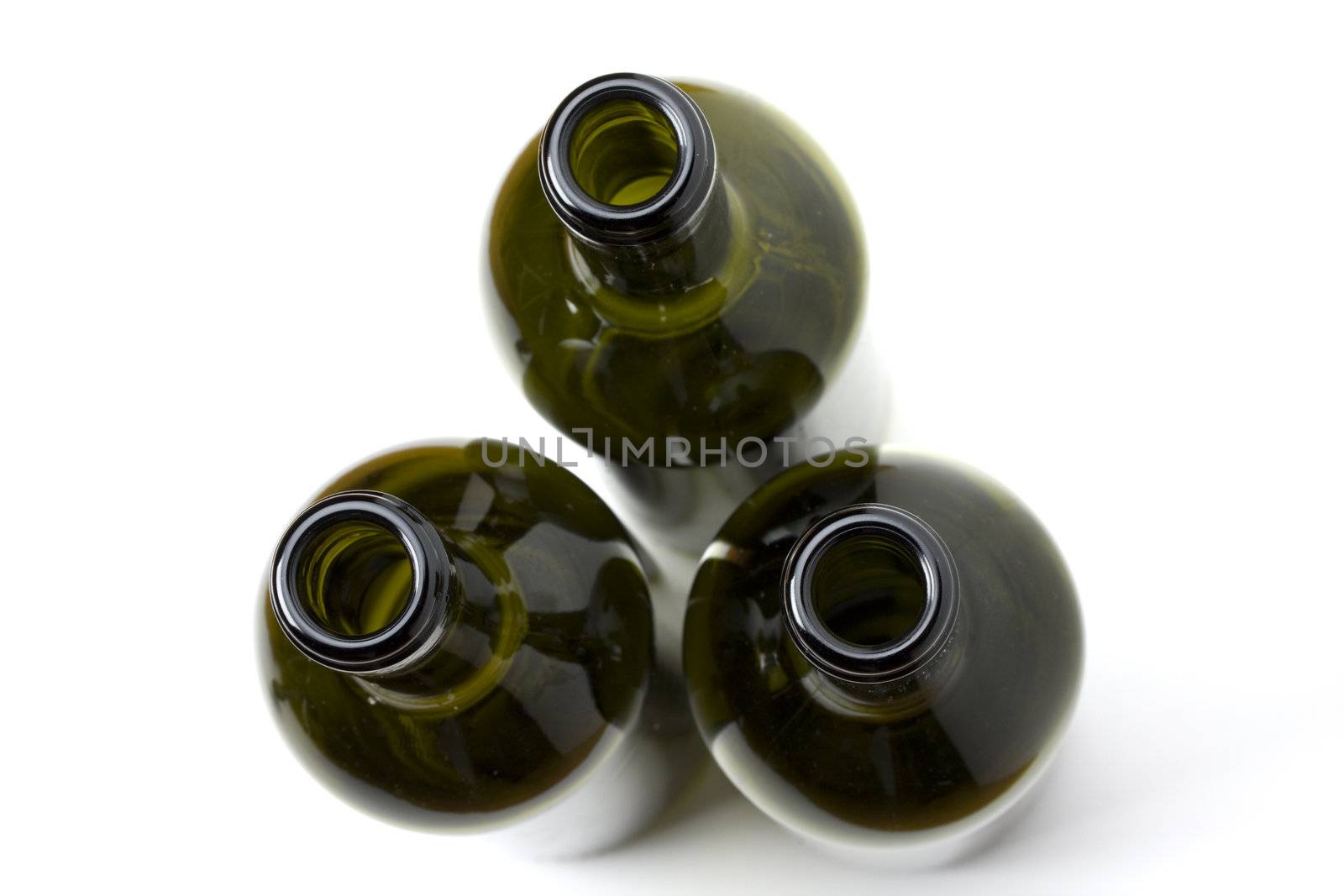 three wine bottles seen from top on white background by bernjuer