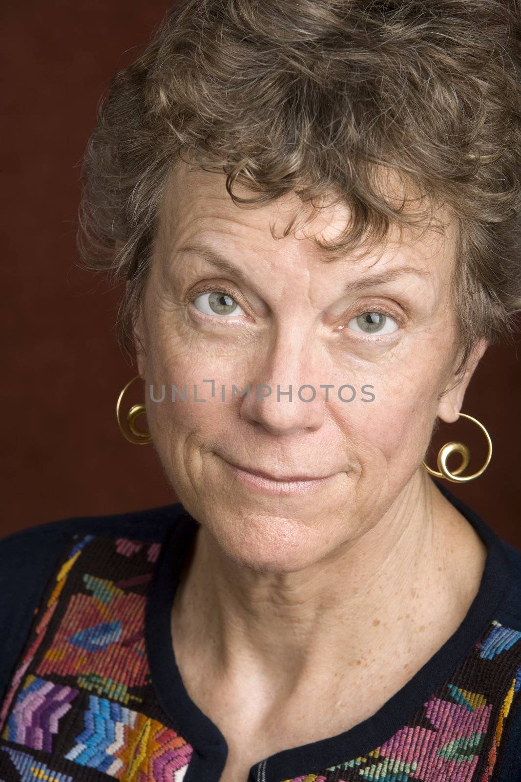 Portrait of a smiling senior woman in an embroidered shirt