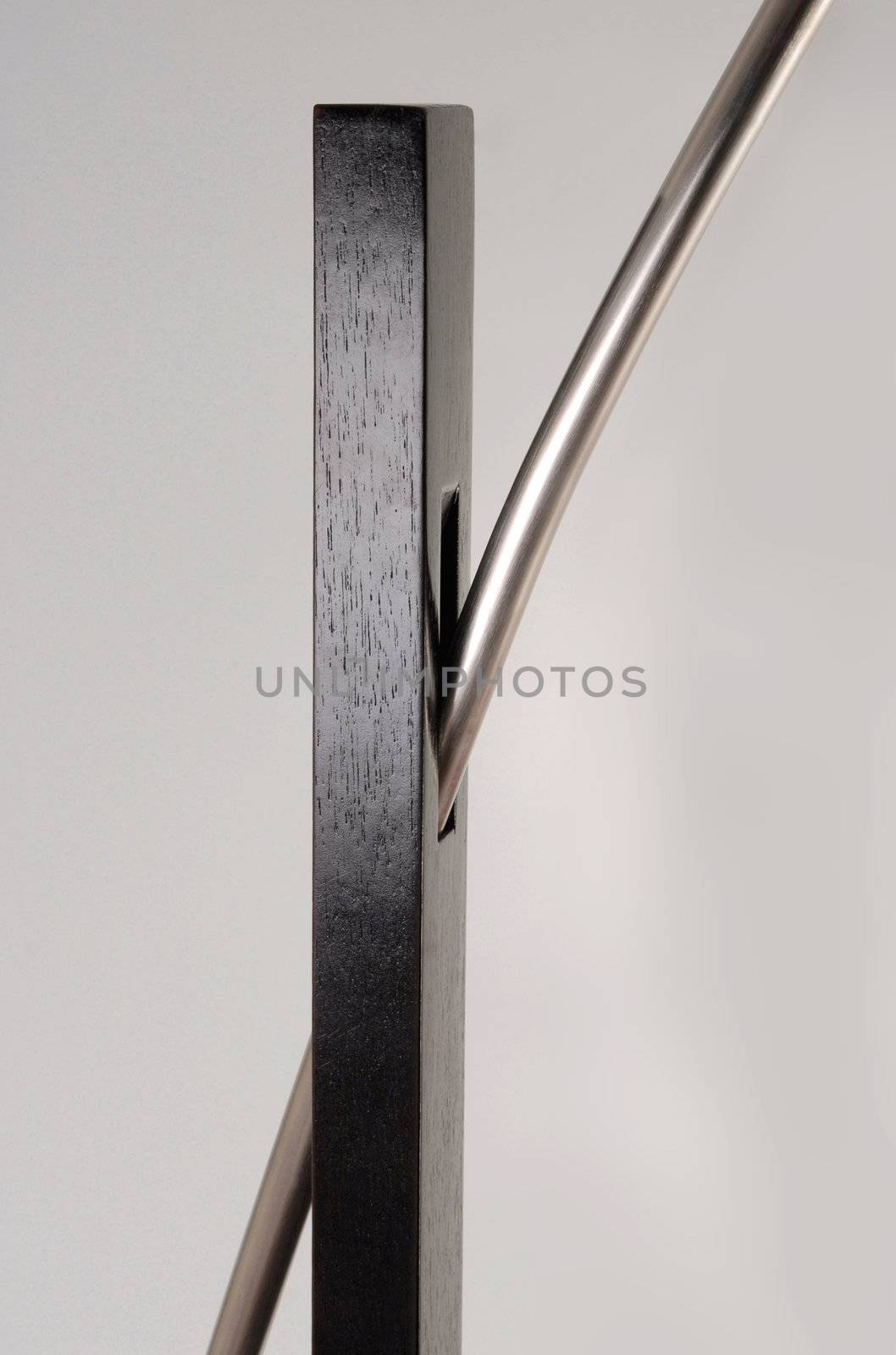 Metallic and wooden contemporary floor lamp detail.  Isolated object
