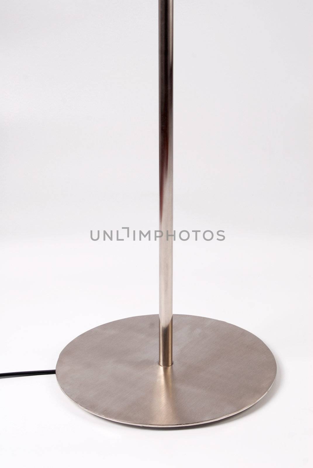 Close up of the bottom of a contemporary floor lamp. Isolated on white background