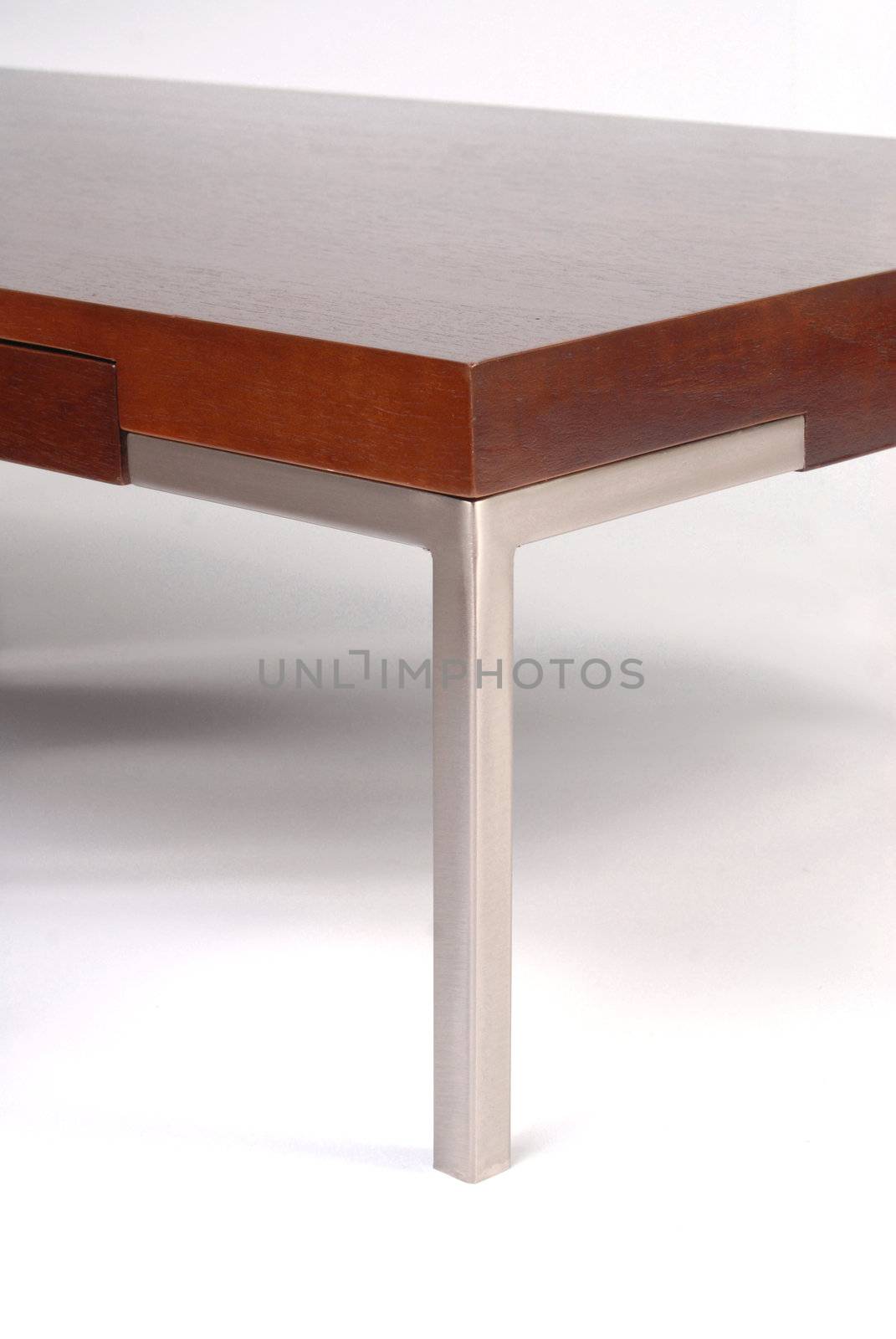 Wooden and metal coffee table corner detail. White background