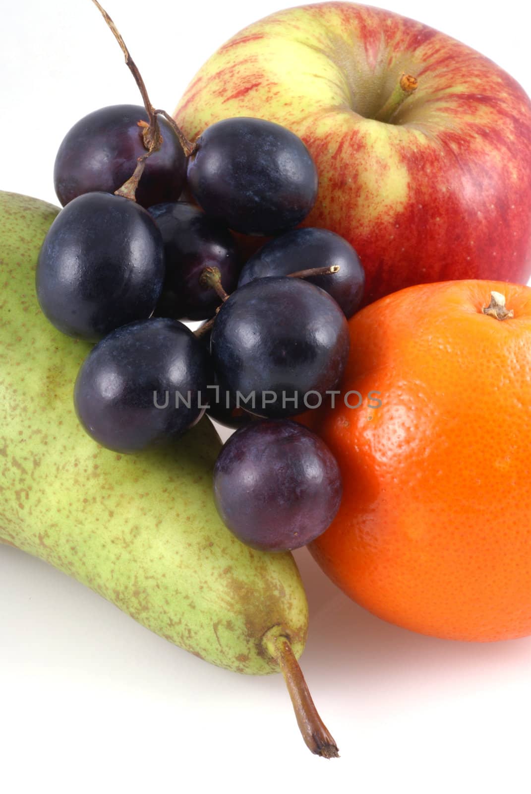 An apple, pear, orange and bunch of grapes on a white background. 