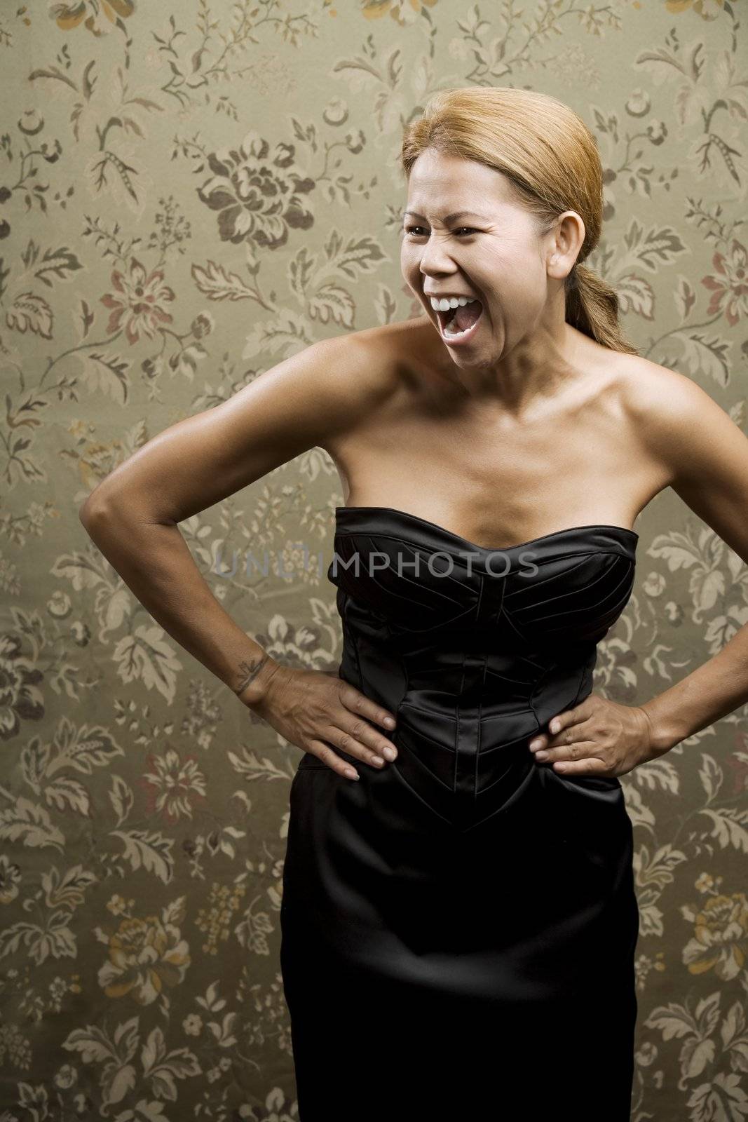 Pretty Ethnic Woman Laughing in front of a Flowered background