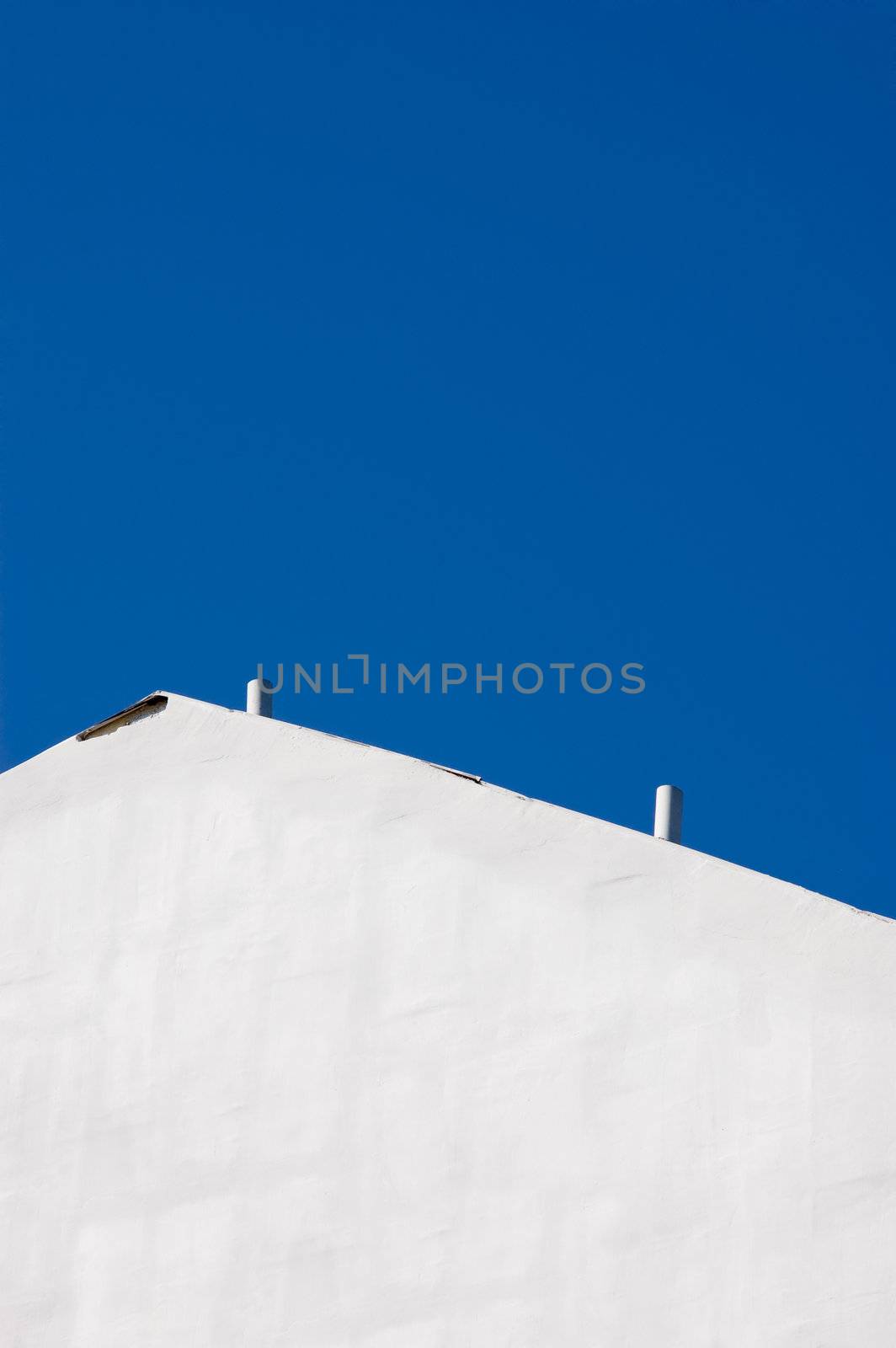 white wintage wall against the deep blue sky