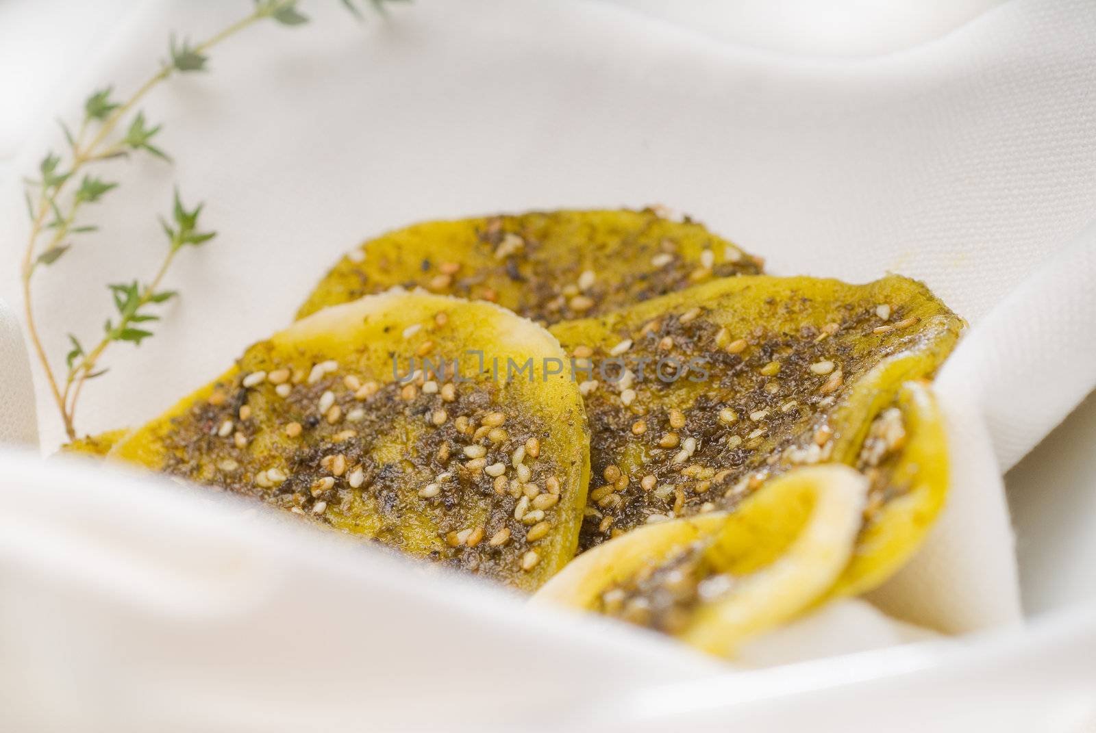 lebanese manouche or manoushe ,lebanese pizza with thyme and sesame seeds,zaatar, and extra virgin olive oil on top