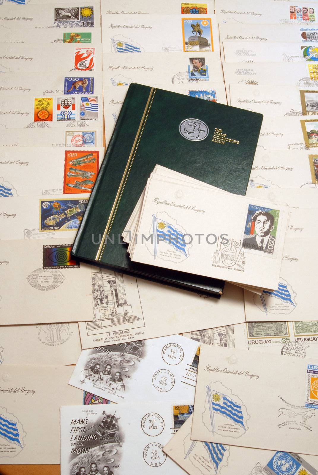 Collection of postcards with stamps from Uruguay and other vintage ones. Hard-cover stamp album over them