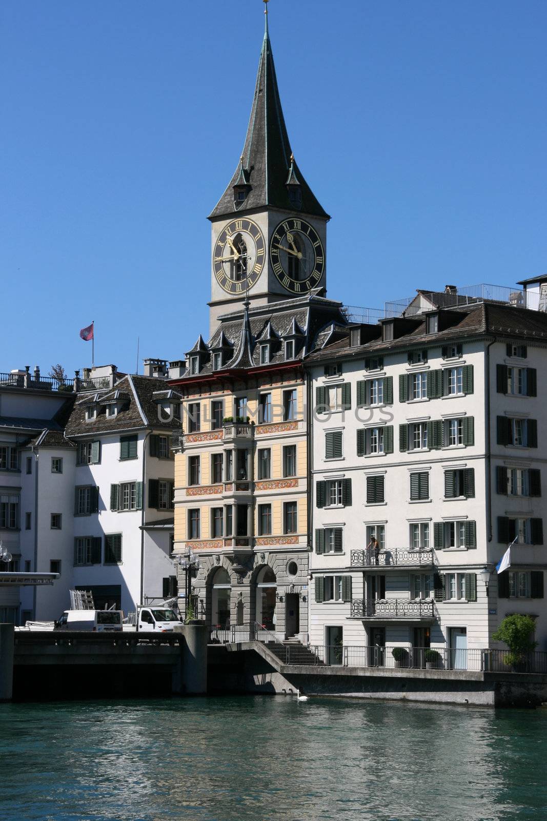 Zurich cityscape. St. Peter's Church tower with world's largest church clock face. Swiss city.