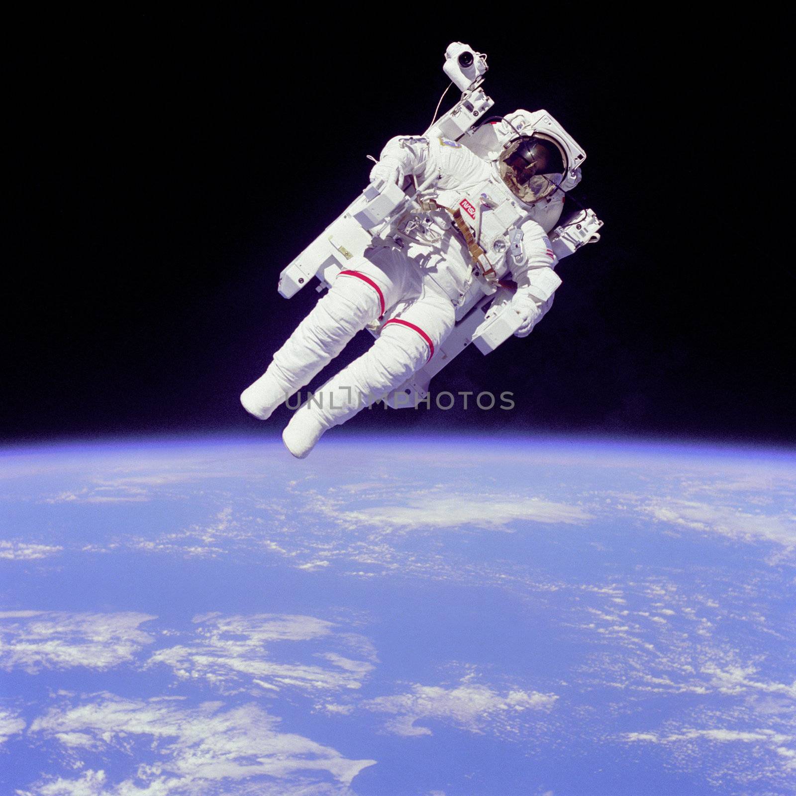 Mission Specialist Bruce McCandless II ventured further away from the confines and safety of his ship than any previous astronaut ever has. This space first was made possible by the Manned Manuevering Unit or MMU, a nitrogen jet propelled backpack. After a series of test maneuvers inside and above Challenger's payload bay, McCandless went "free-flying" to a distance of 320 feet away from the Orbiter. Photo taken: 02/11/1984. ** Credit: NASA / yaymicro.com **