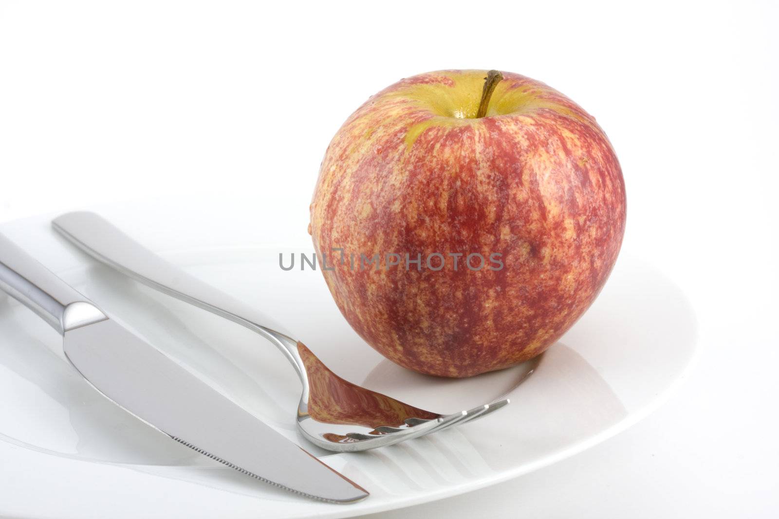 cutlery and an apple on a plate by bernjuer