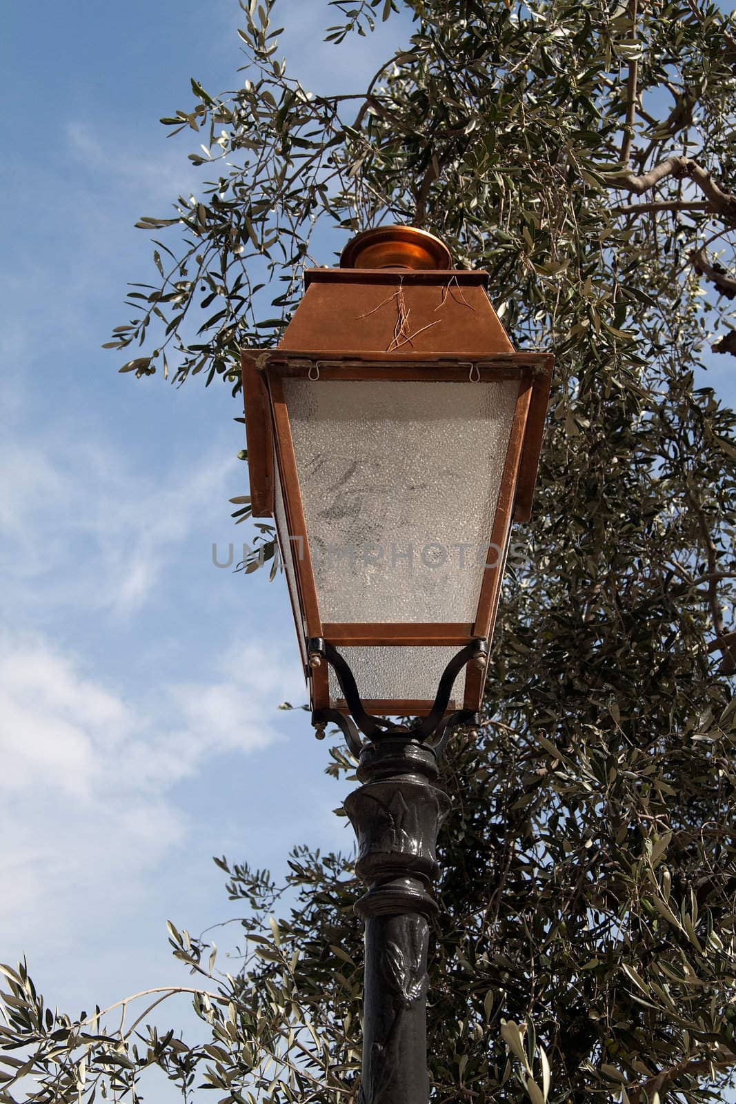 A old looking street light with a bronze top