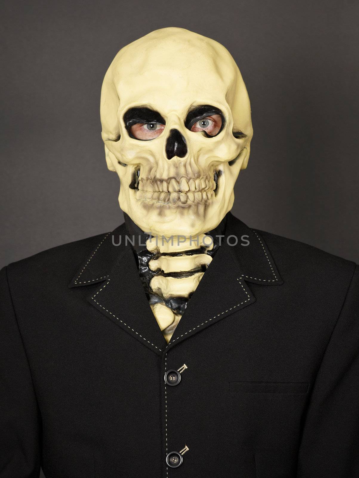 Portrait of a man in a mask of death on a black background