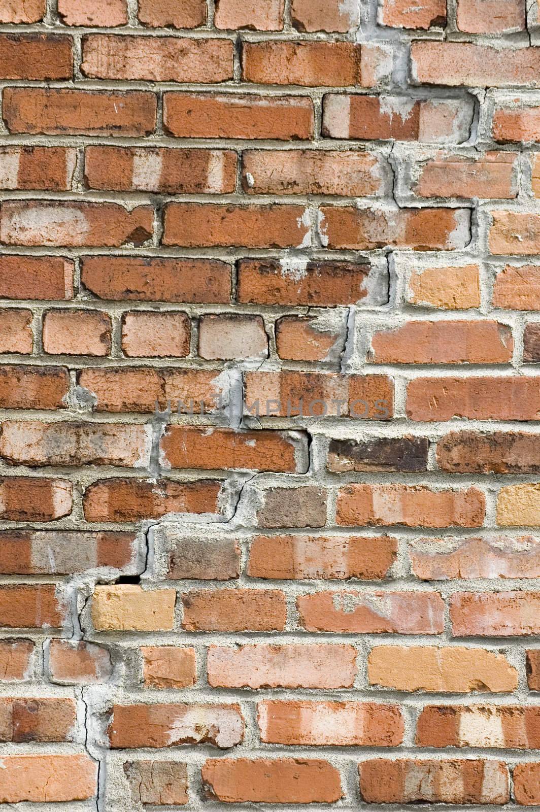 a close up view of a cracked brick wall