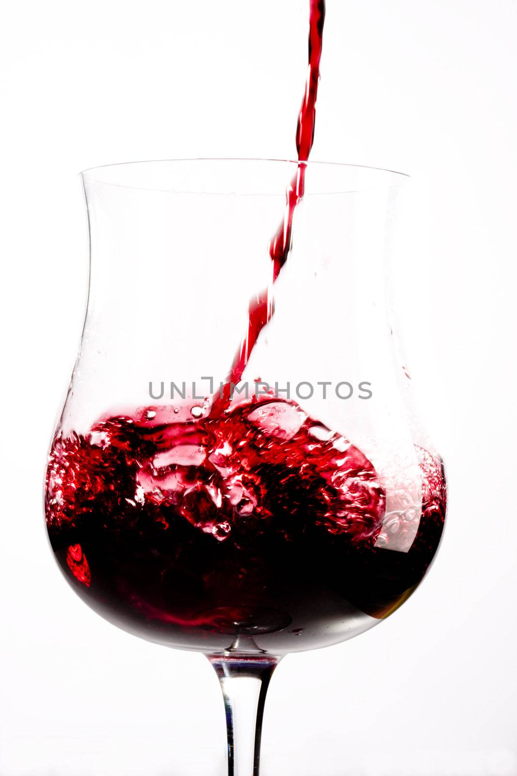 red wine splashing in a glass by bernjuer