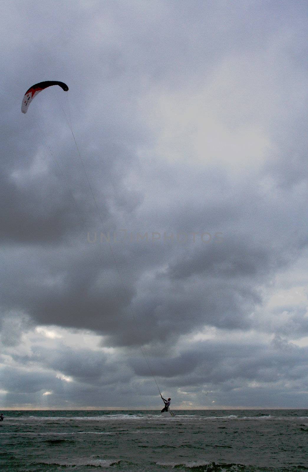 kite surfer on a cloudy day by bernjuer