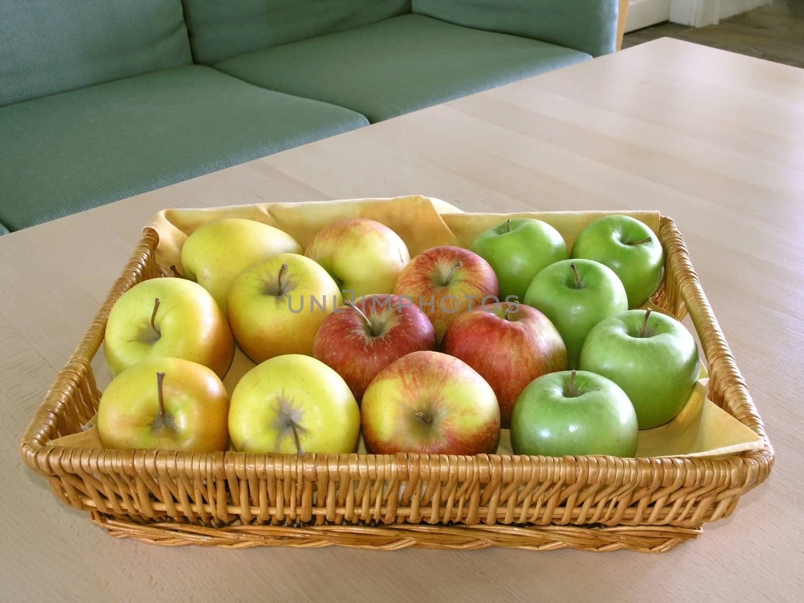 red, green  and yellow apples in basket