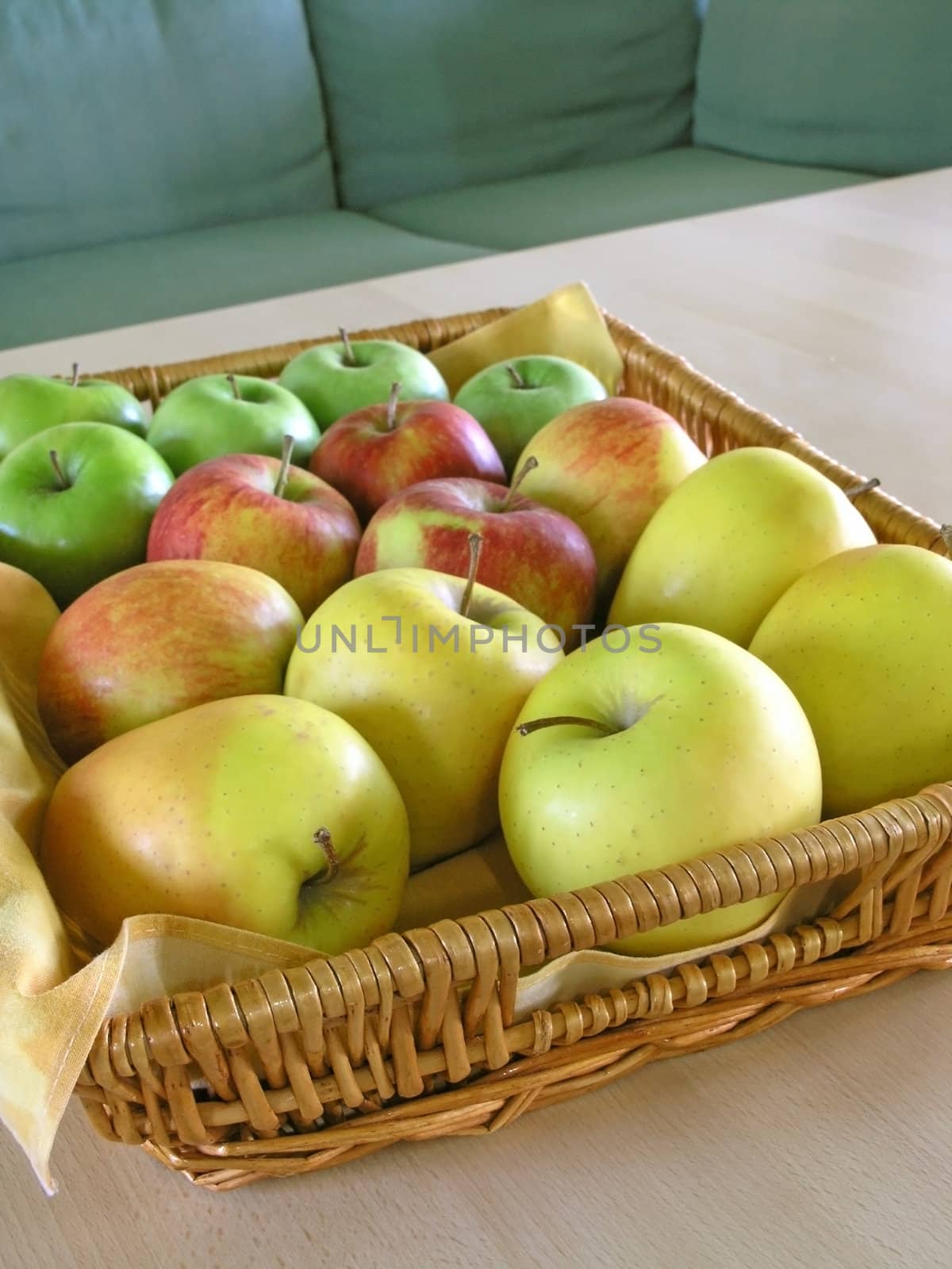 red, green  and yellow apples in basket