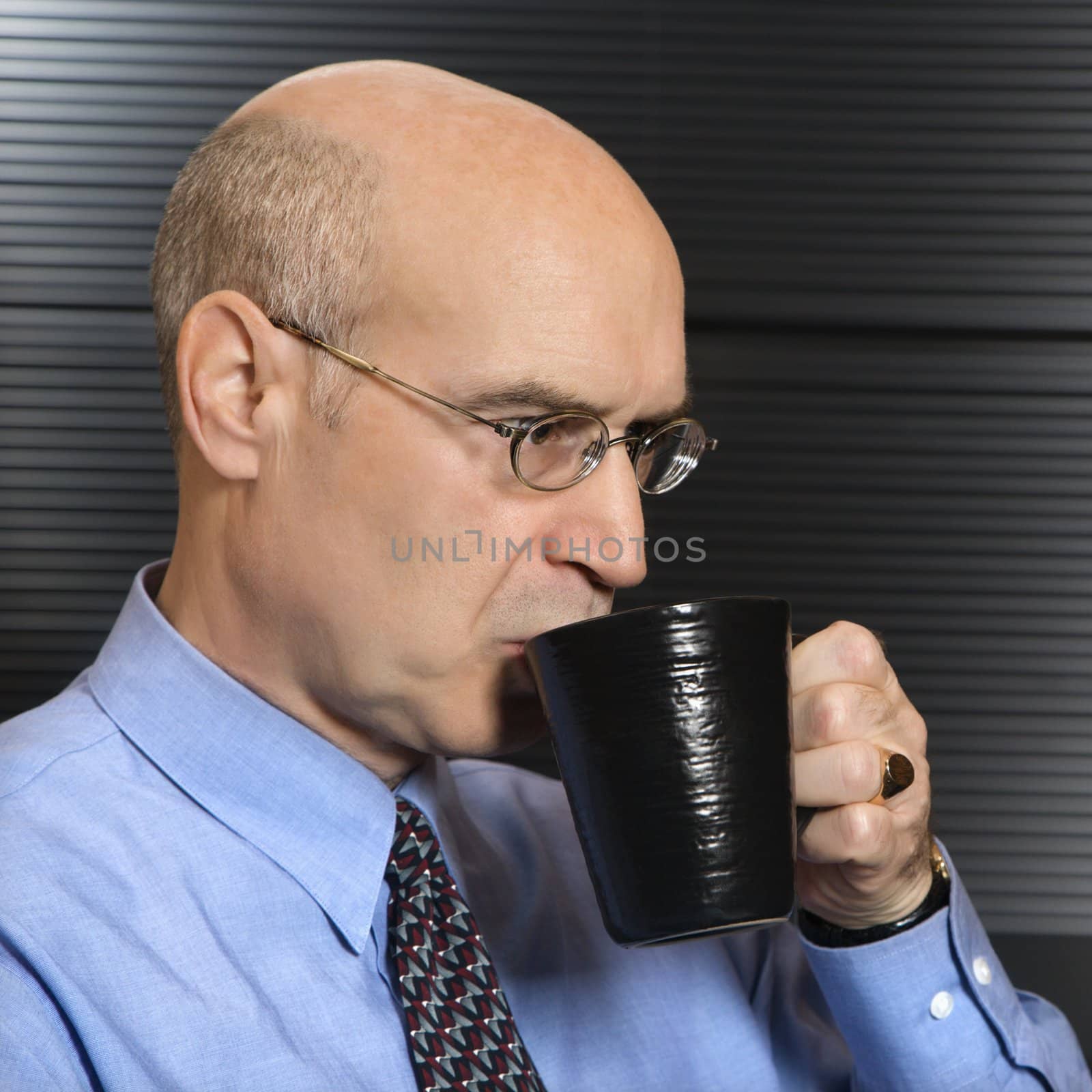 Businessman drinking coffee. by iofoto