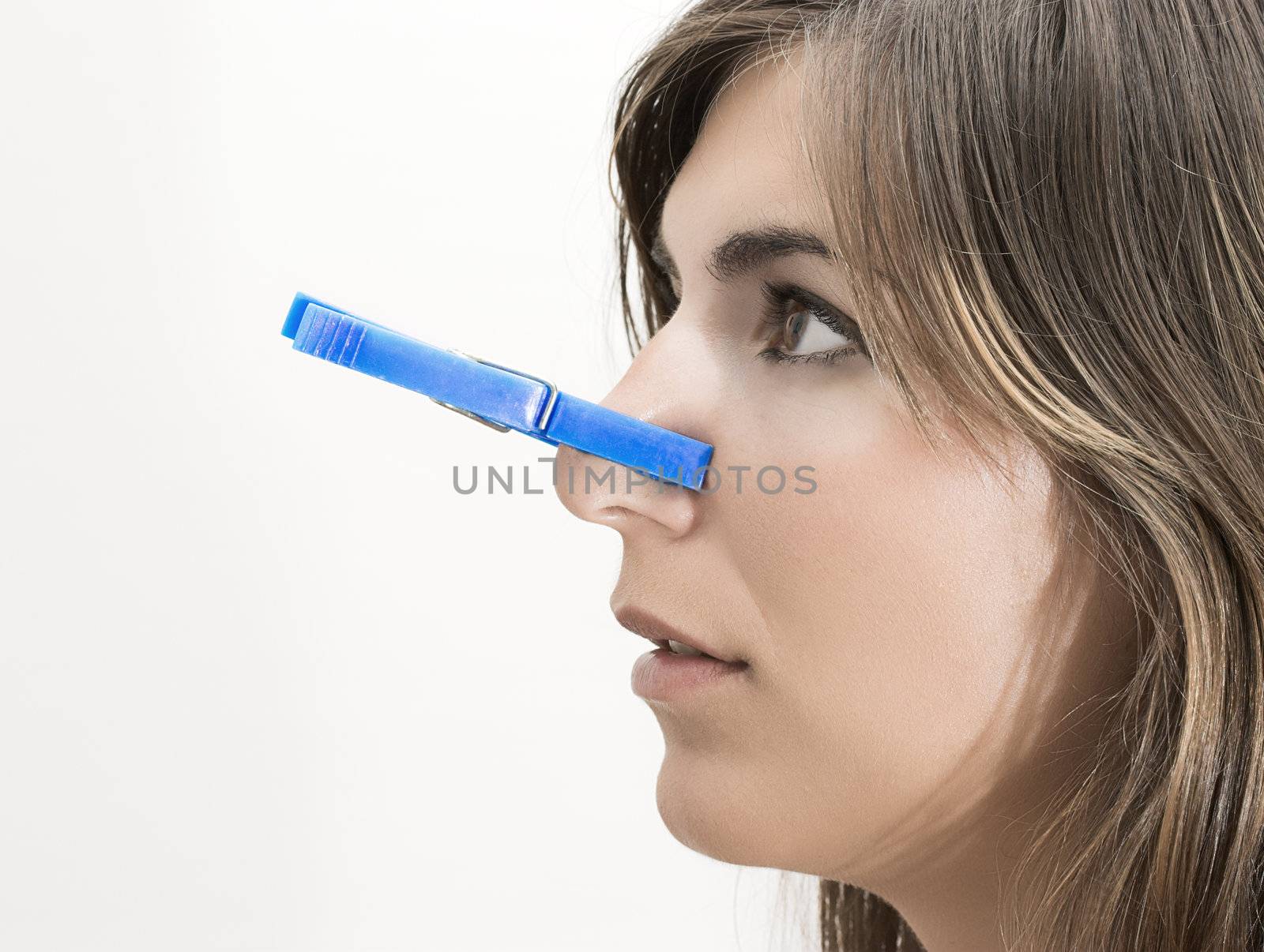 Woman with clothespin in the nose