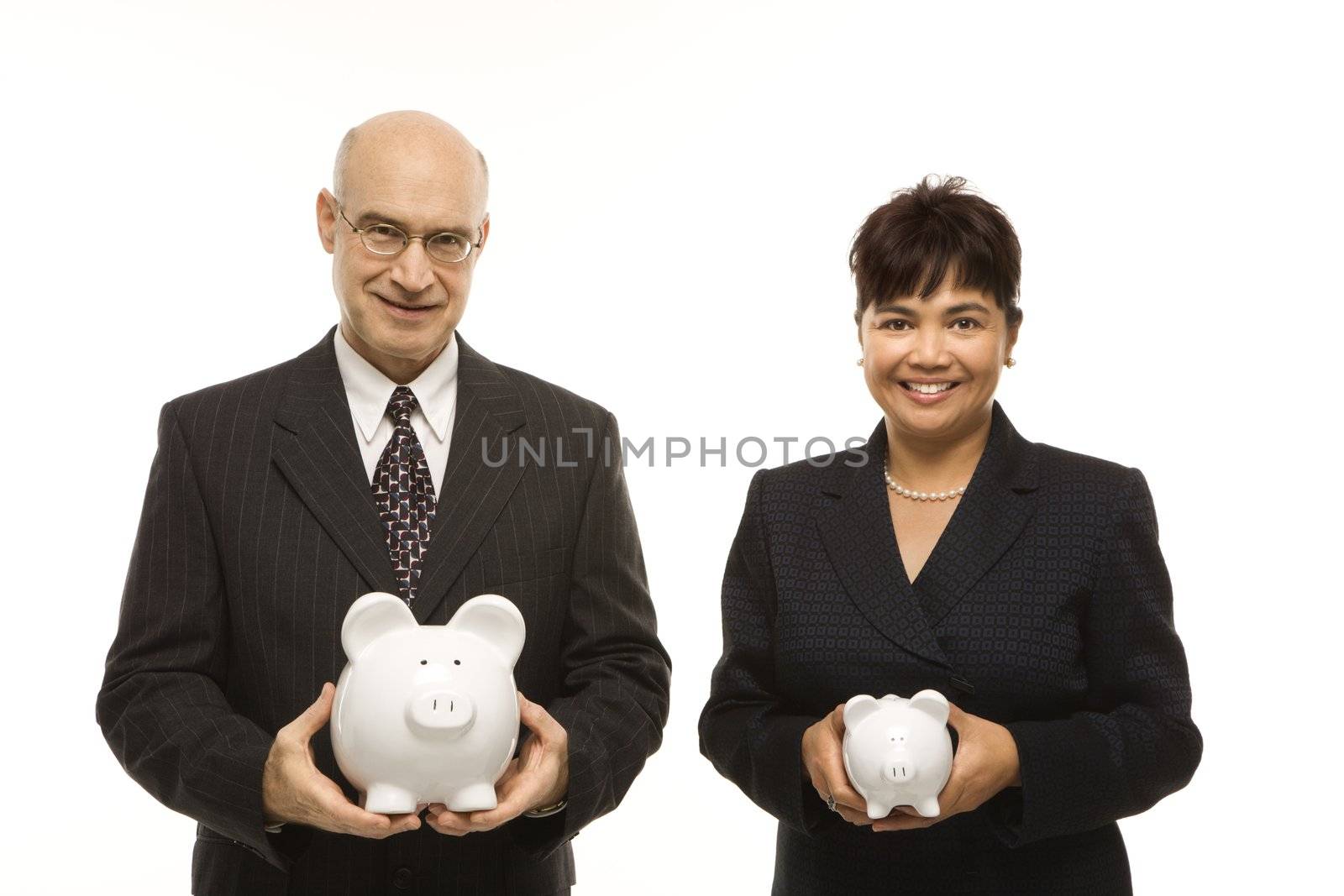 Caucasian middle-aged businessman and Filipino businesswoman holding different sized piggybanks.