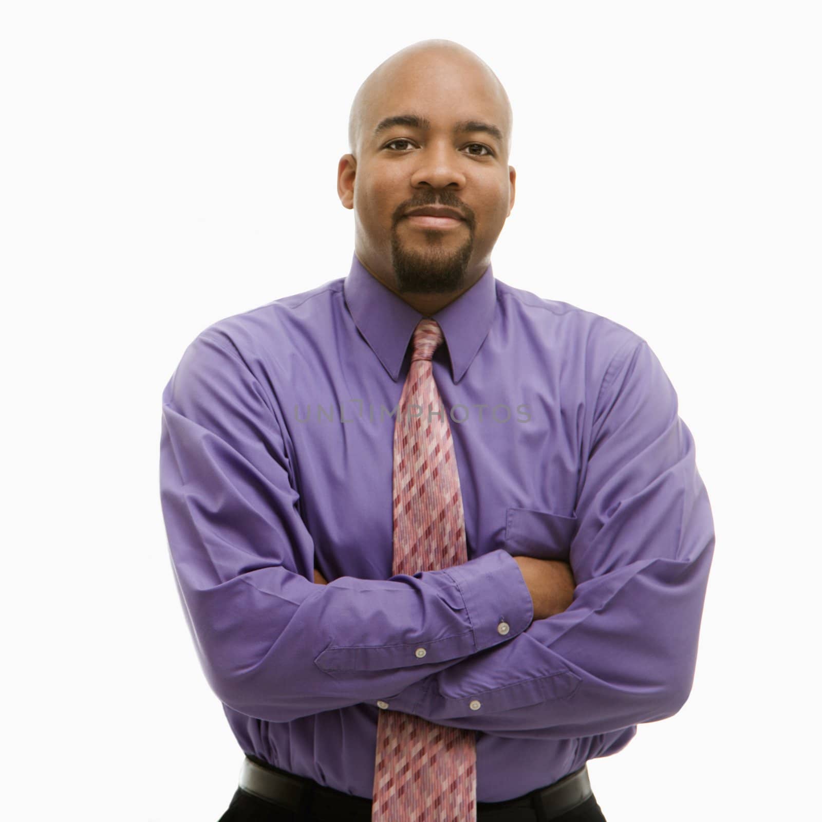 African-American businessman portrait with arms crossed looking at viewer.