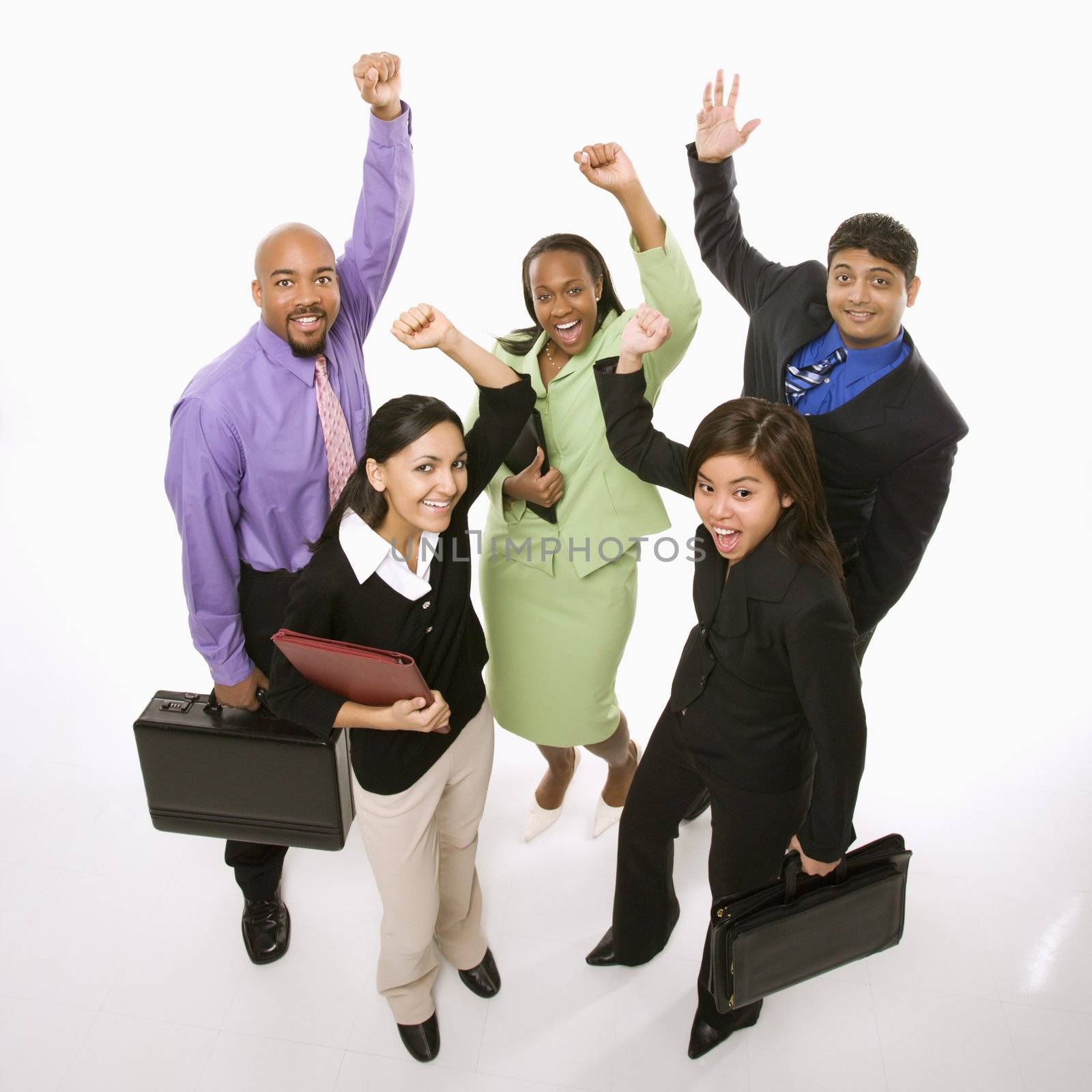 Portrait of multi-ethnic business group standing holding briefcases and cheering.