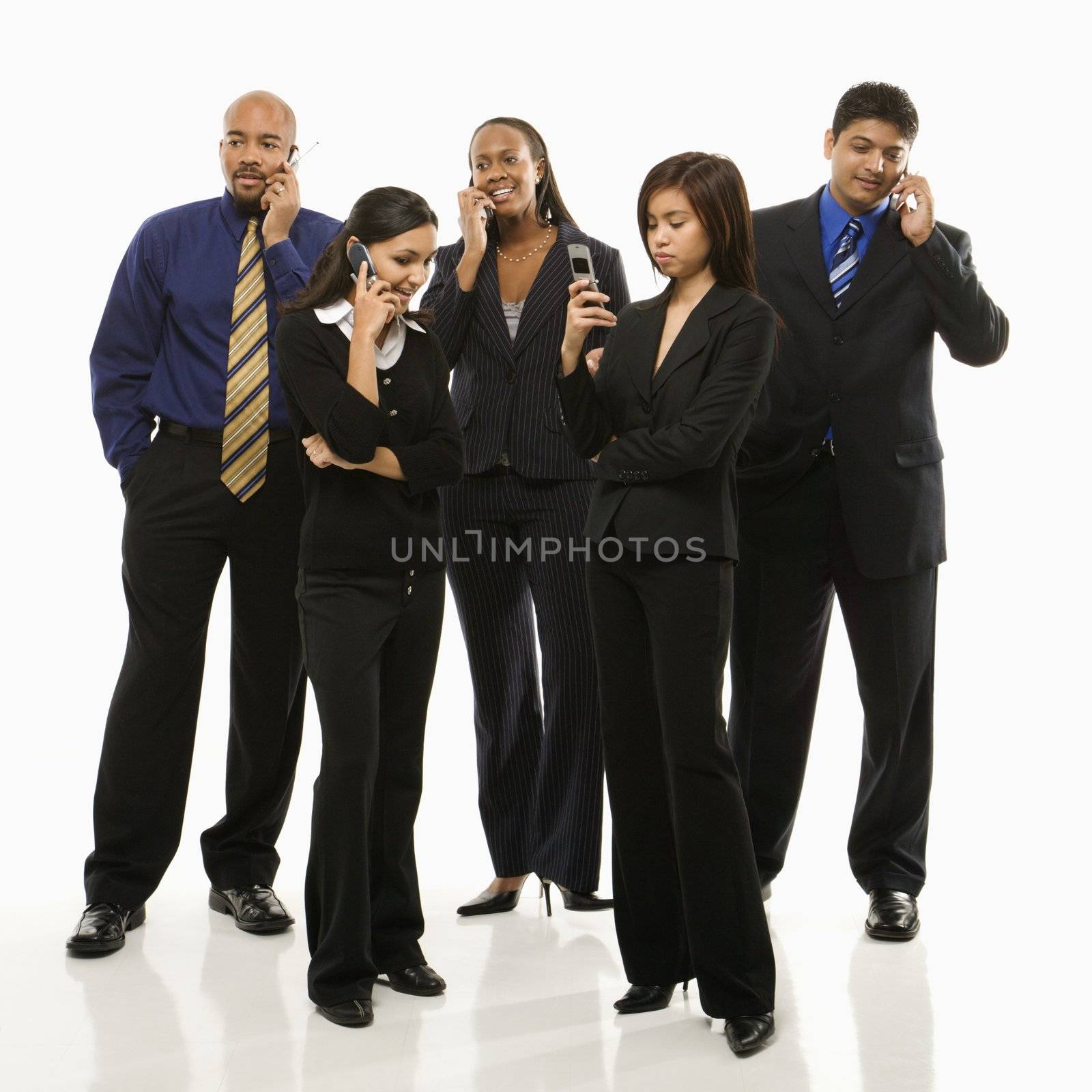 Multi-ethnic business group of men and women standing talking on cell phones.